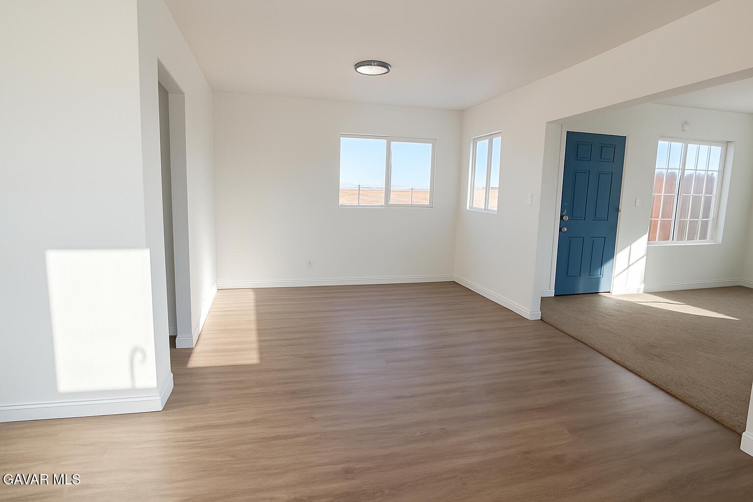 8445 Gaskell Road Rosamond, CA 93560 - Photo 4 of 13 a view of an empty room with wooden floor and a window