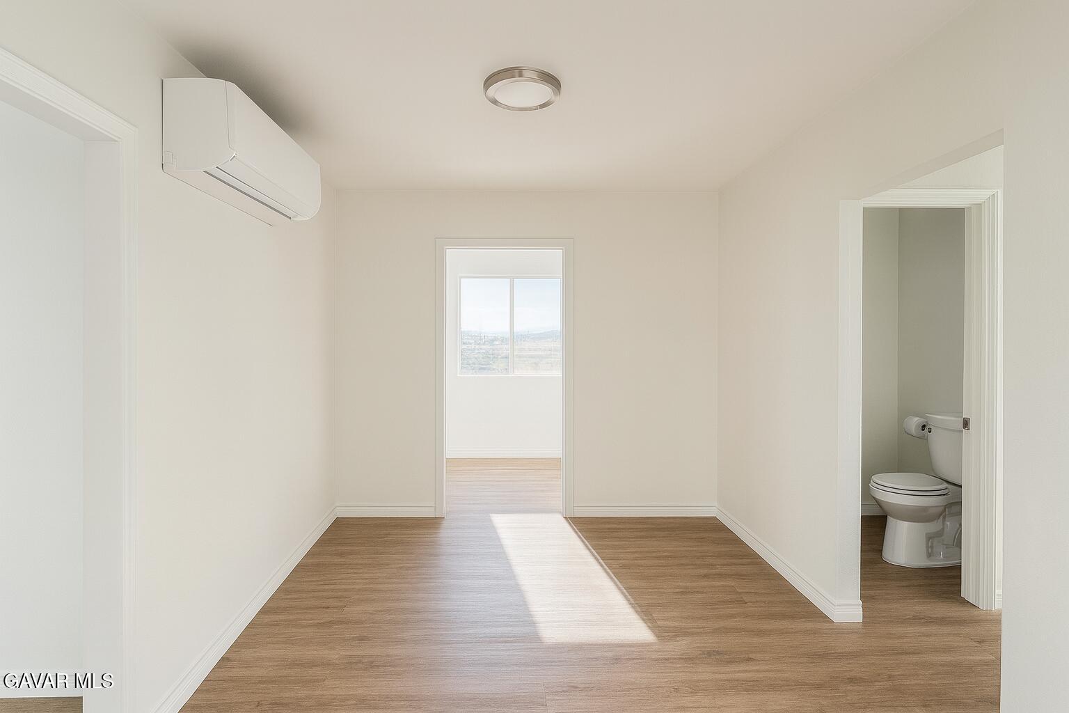8445 Gaskell Road Rosamond, CA 93560 - Photo 5 of 13 a view of a room with wooden floor and a toilet
