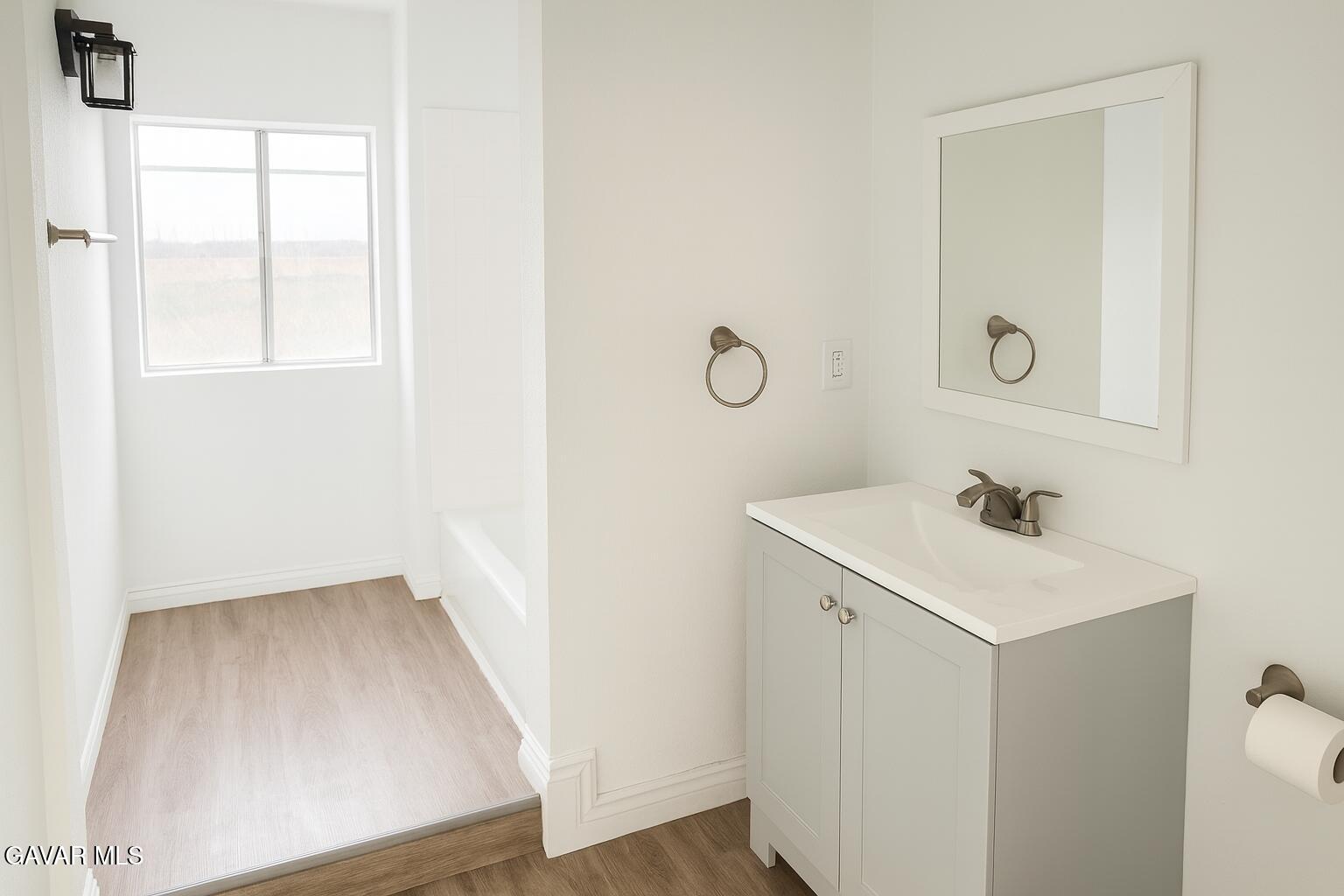 8445 Gaskell Road Rosamond, CA 93560 - Photo 7 of 13 a bathroom with a sink and a mirror