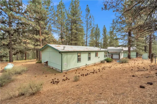 a view of a house with a yard covered in snow