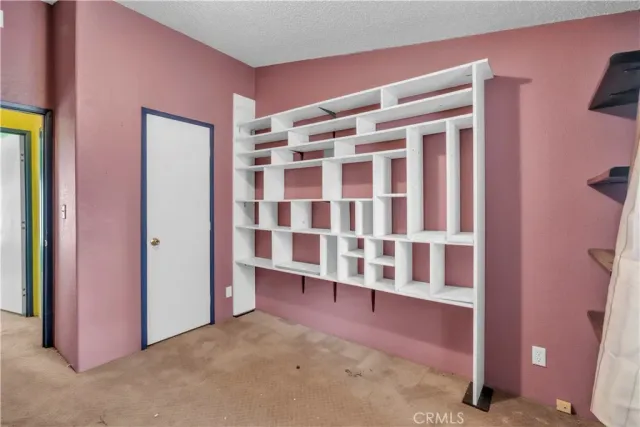 an aerial view of a house with pool and garden