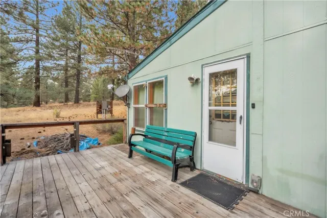a view of a deck with wooden floor and fence