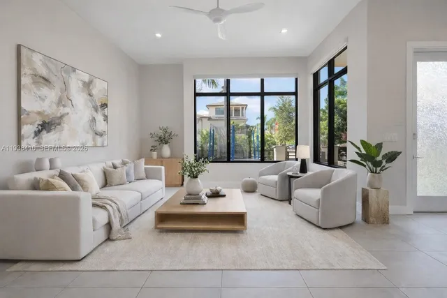 a living room with furniture and large windows