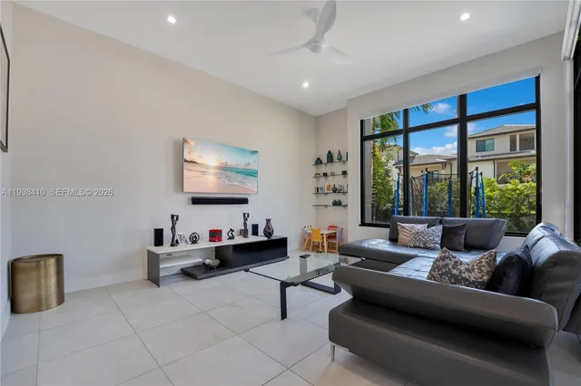 a living room with furniture and a large window