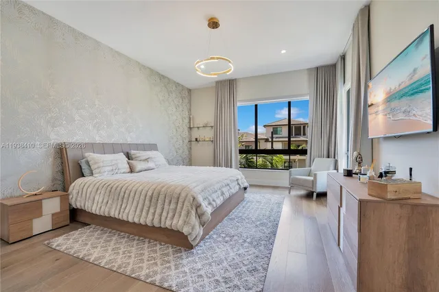 a bedroom with a bed and a large window