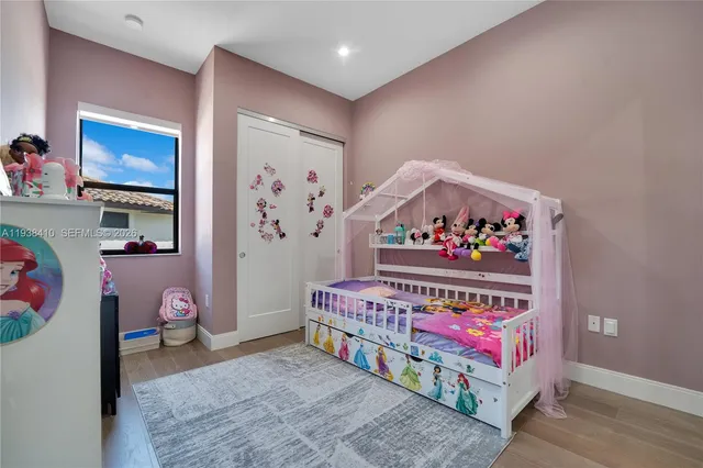 a bedroom with furniture and a flat screen tv