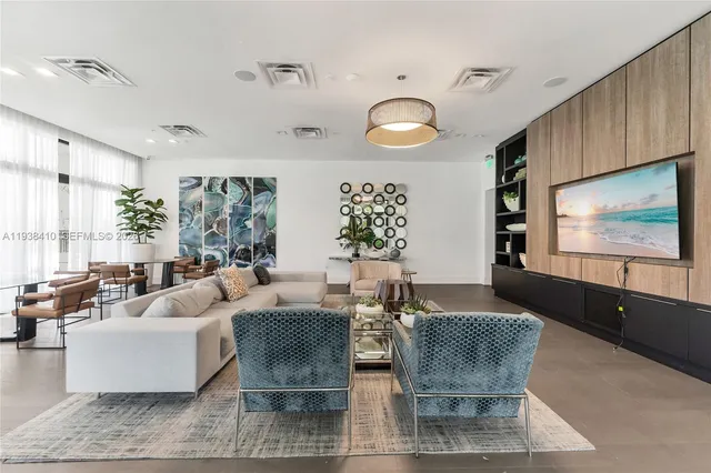a kitchen with stainless steel appliances granite countertop table chairs sink and cabinets
