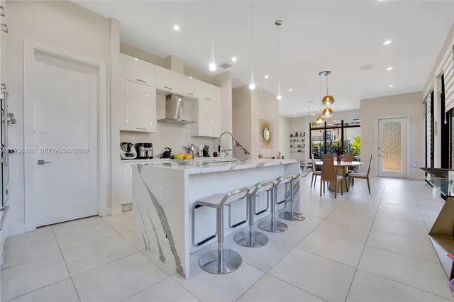 a kitchen with stainless steel appliances granite countertop a refrigerator and a stove top oven
