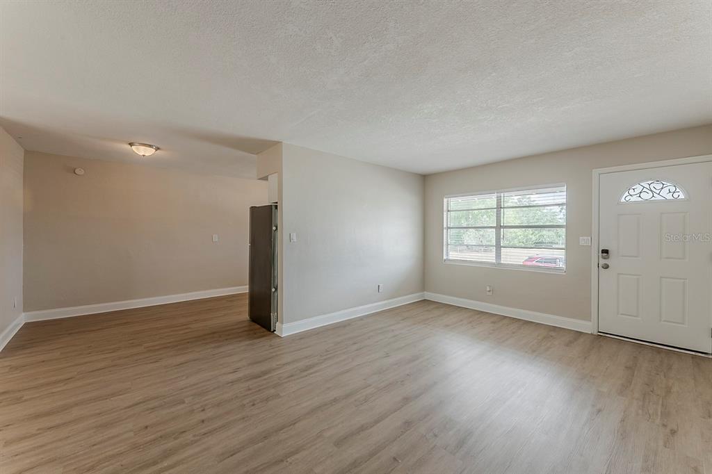 5500 Riviera Drive Orlando, FL 32808 - Photo 12 of 48 an empty room with wooden floor and windows