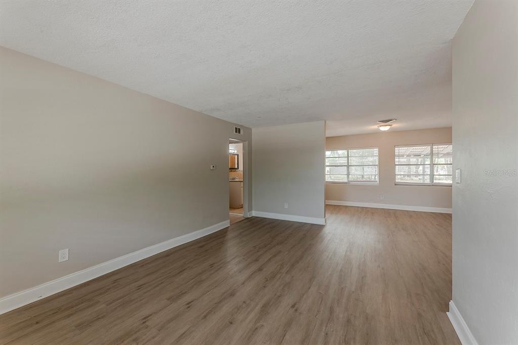 5500 Riviera Drive Orlando, FL 32808 - Photo 13 of 48 an empty room with wooden floor and windows