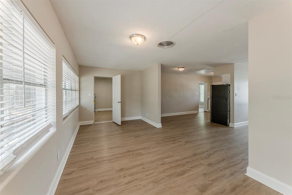 5500 Riviera Drive Orlando, FL 32808 - Photo 15 of 48 a view of a big room with wooden floor and windows