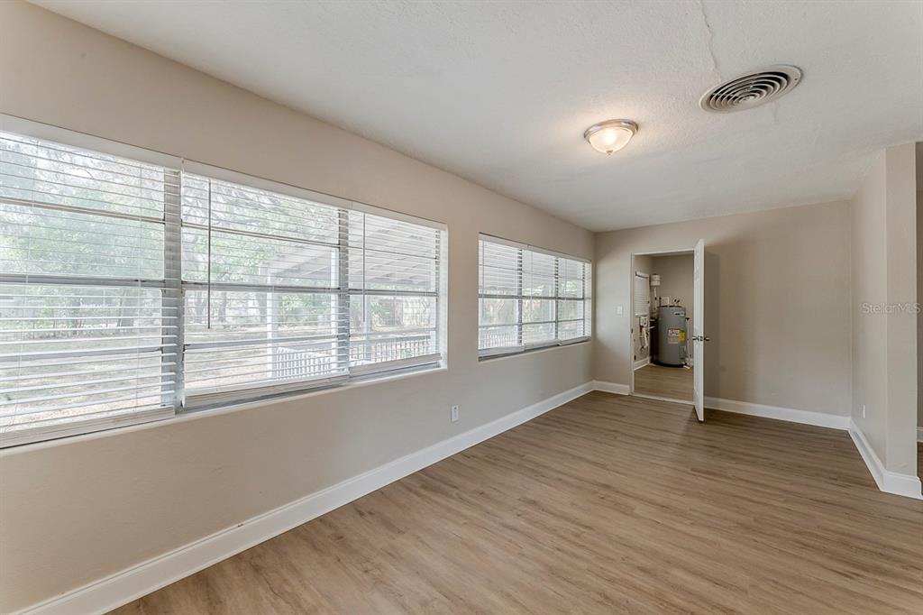 5500 Riviera Drive Orlando, FL 32808 - Photo 16 of 48 an empty room with wooden floor and windows