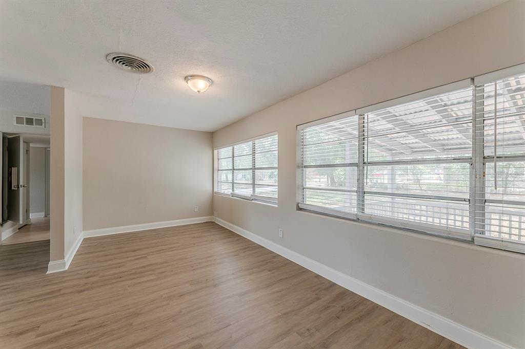 5500 Riviera Drive Orlando, FL 32808 - Photo 17 of 48 a view of an empty room with wooden floor and a window