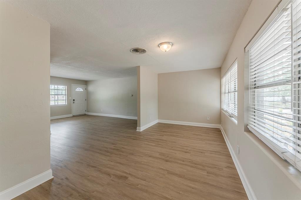 5500 Riviera Drive Orlando, FL 32808 - Photo 18 of 48 wooden floor in an empty room with a window