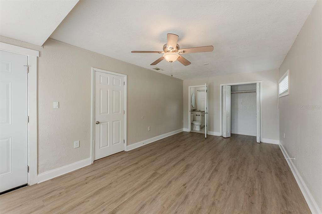 5500 Riviera Drive Orlando, FL 32808 - Photo 21 of 48 a view of empty room with wooden floor and ceiling fan