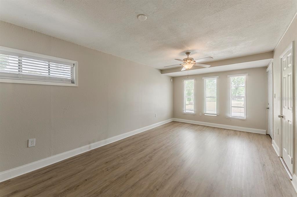 5500 Riviera Drive Orlando, FL 32808 - Photo 23 of 48 a view of an empty room with wooden floor and a window