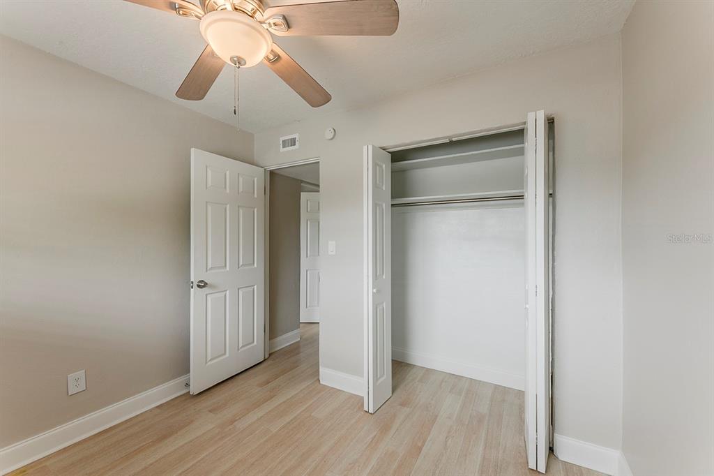 5500 Riviera Drive Orlando, FL 32808 - Photo 28 of 48 an empty room with wooden floor fan and windows