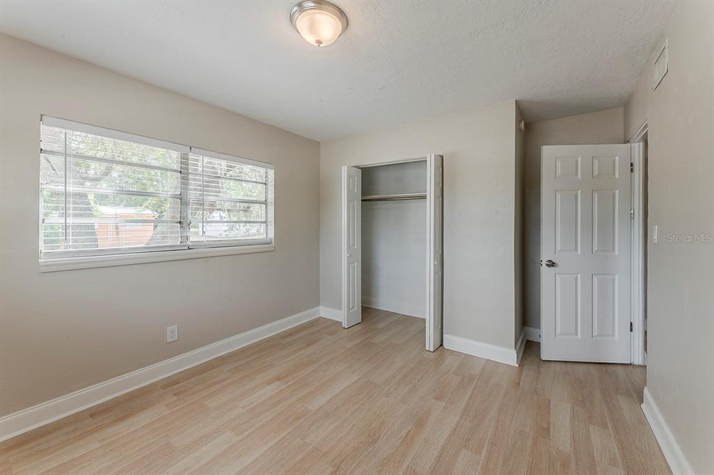5500 Riviera Drive Orlando, FL 32808 - Photo 30 of 48 an empty room with wooden floor and windows