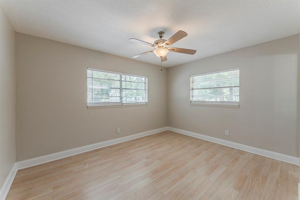 5500 Riviera Drive Orlando, FL 32808 - Photo 34 of 48 a view of an empty room with wooden floor and a window