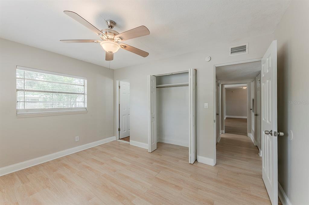 5500 Riviera Drive Orlando, FL 32808 - Photo 35 of 48 a view of an empty room with wooden floor