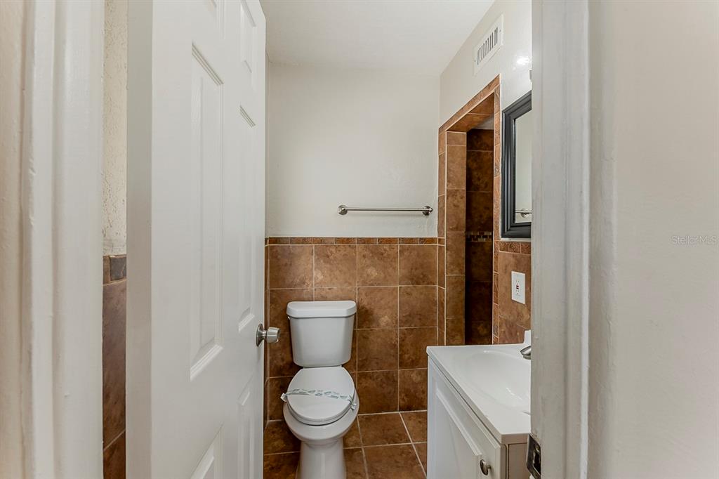 5500 Riviera Drive Orlando, FL 32808 - Photo 38 of 48 a white toilet sitting next to a bathroom sink