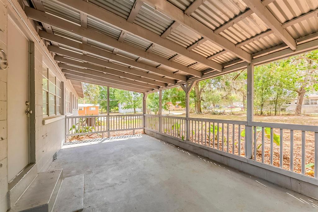 5500 Riviera Drive Orlando, FL 32808 - Photo 42 of 48 a view of a porch with wooden floor