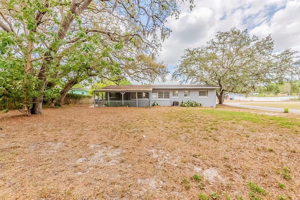 5500 Riviera Drive Orlando, FL 32808 - Photo 46 of 48 a front view of house with yard and trees around