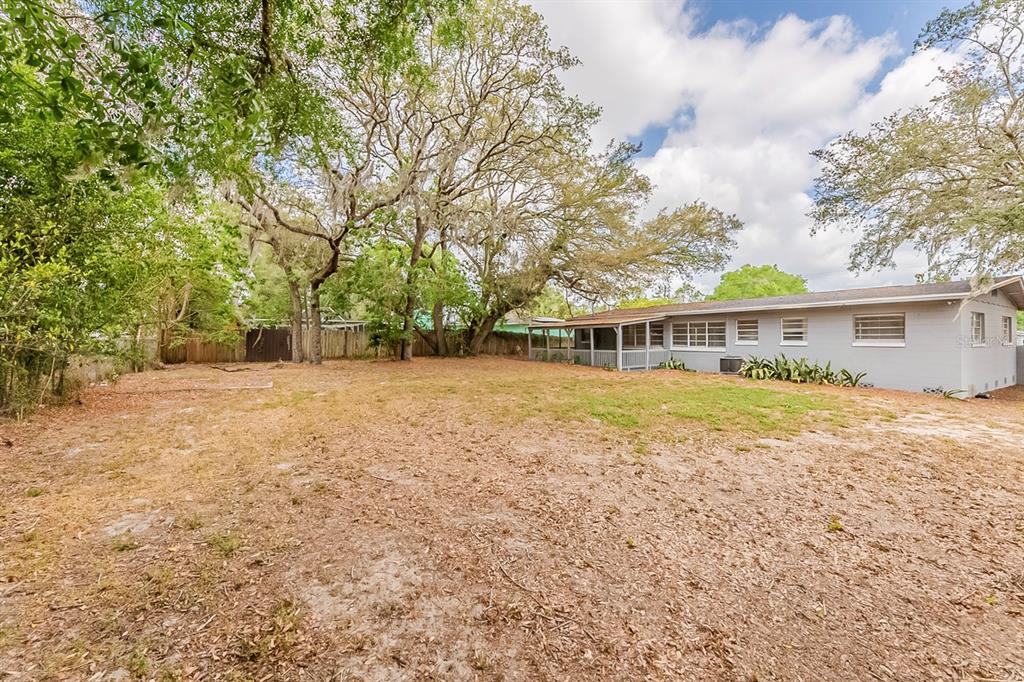 5500 Riviera Drive Orlando, FL 32808 - Photo 47 of 48 a front view of house with yard and trees around