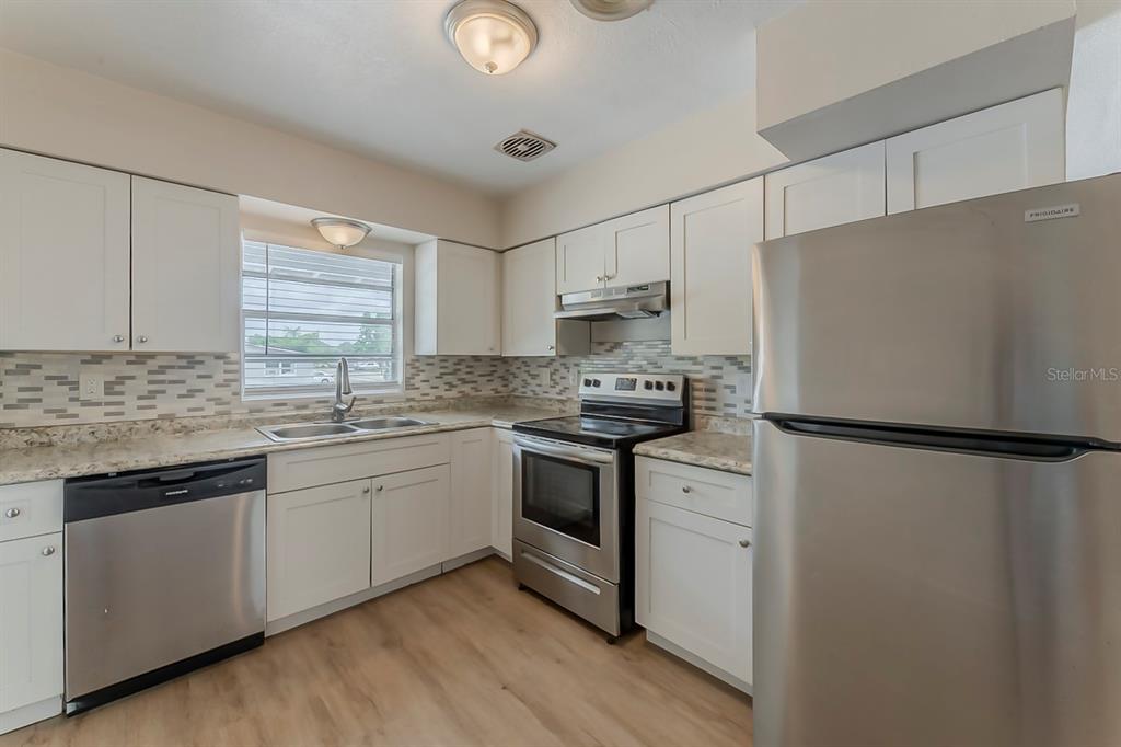 5500 Riviera Drive Orlando, FL 32808 - Photo 6 of 48 a refrigerator freezer sitting inside of a kitchen