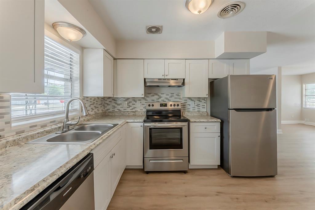 5500 Riviera Drive Orlando, FL 32808 - Photo 7 of 48 a kitchen with a sink cabinets and stainless steel appliances
