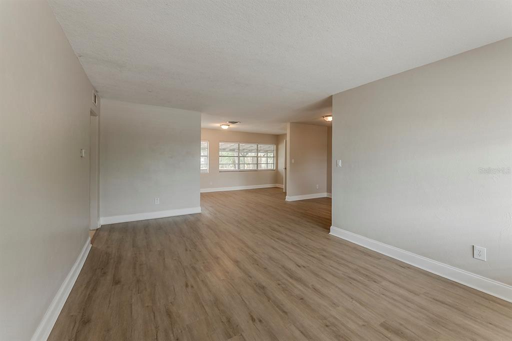 5500 Riviera Drive Orlando, FL 32808 - Photo 10 of 48 wooden floor in an empty room with a window