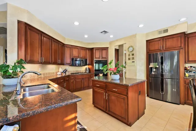 a kitchen with stainless steel appliances granite countertop a stove sink microwave and cabinets
