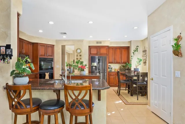 a view of a dining room with furniture and a chandelier