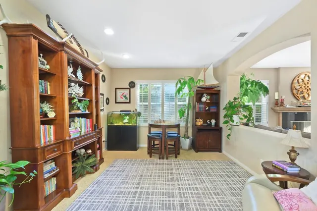 a living room with furniture fireplace and a large window