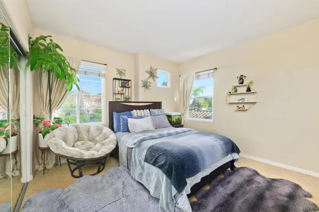 a bathroom with a double vanity sink a toilet a shower and a mirror