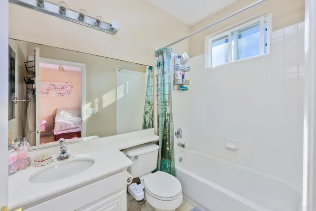 a view of a white house with a yard and potted plants