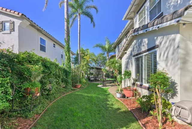 a front view of a house with a yard and a garden