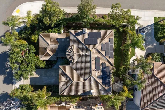 an aerial view of a house with a yard and lake view
