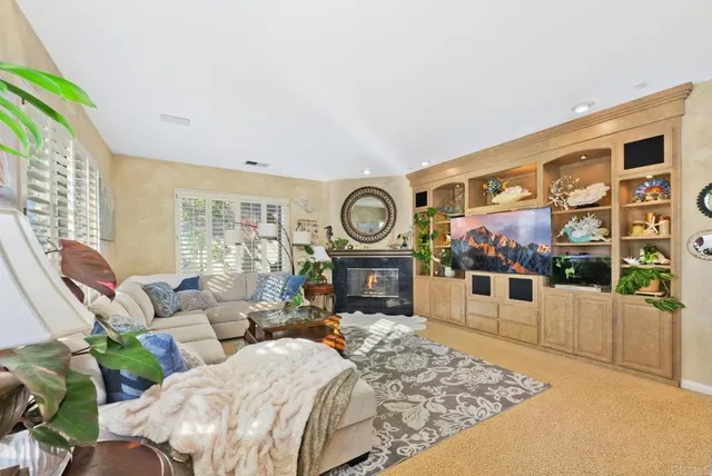 a living room with furniture a rug and a large window