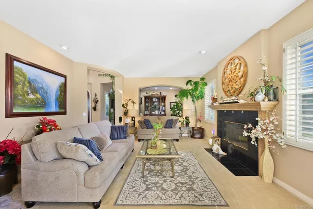 a living room with furniture fireplace and window