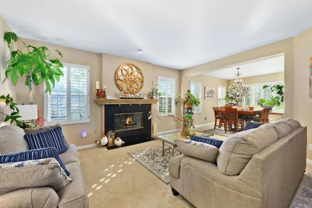 a living room with furniture a large window and a fireplace