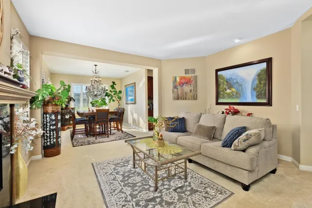 a living room with furniture and flowers