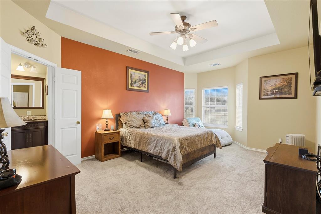 9920 County Road 540 Lavon, TX 75166 - Photo 13 of 32 a bedroom with a bed and a chandelier