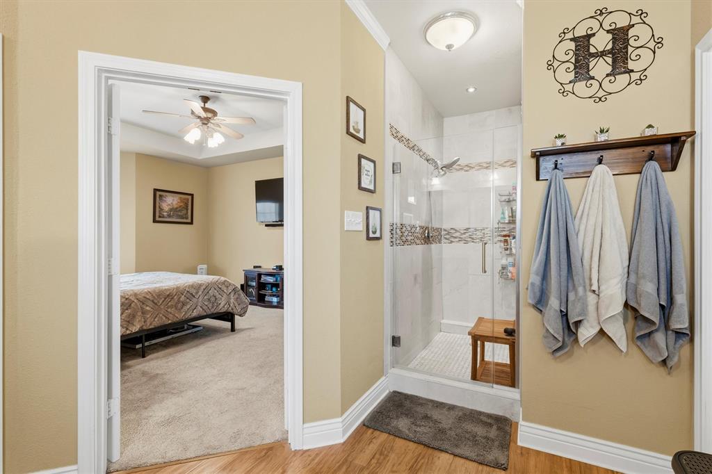 9920 County Road 540 Lavon, TX 75166 - Photo 17 of 32 a en suite bathroom with a tub shower and a sink