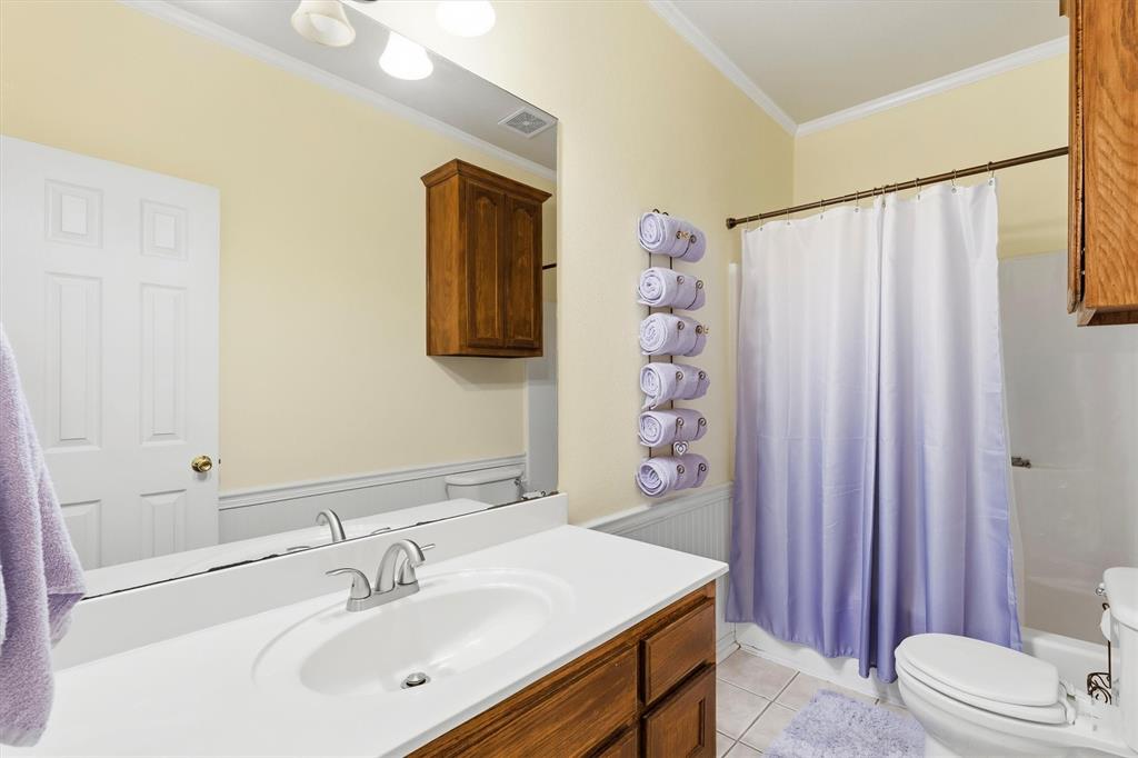 9920 County Road 540 Lavon, TX 75166 - Photo 19 of 32 a bathroom with a sink a toilet and shower curtain