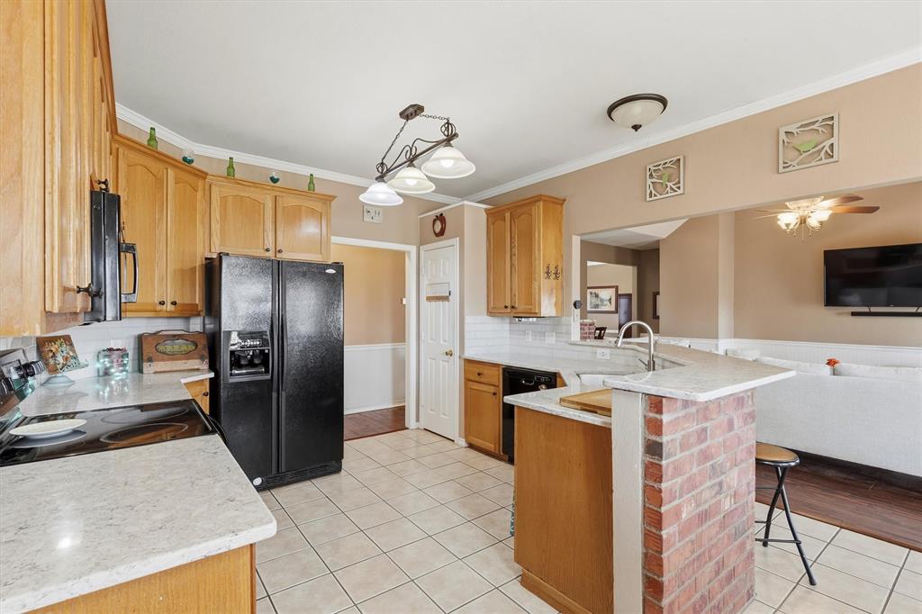 9920 County Road 540 Lavon, TX 75166 - Photo 10 of 32 a kitchen with a refrigerator a sink and a stove