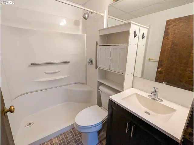 a bathroom with a sink toilet and shower