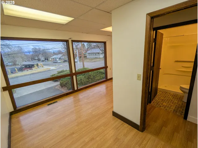 a view of a room with wooden floor