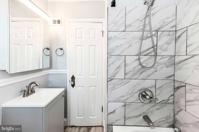 a bathroom with a sink and mirror