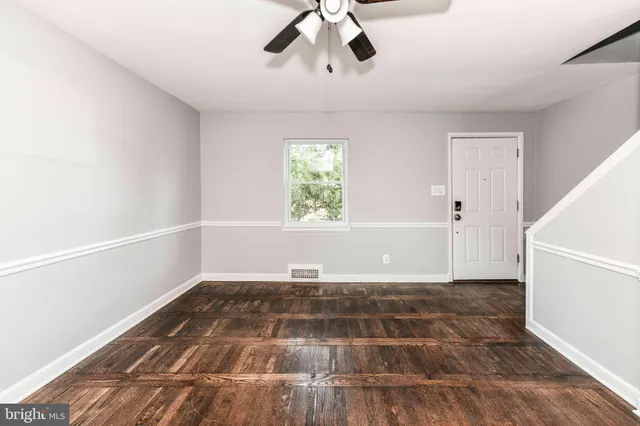 wooden floor in an empty room with a window